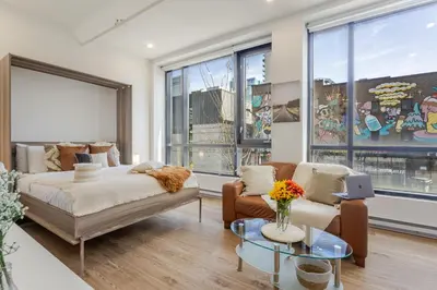 a living room with a bed and a couch at Apartment MTL Dtown Spotlight MTL in Montréal