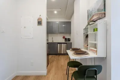 a kitchen and dining room with a table and chairs at Apartment MTL Dtown Spotlight MTL in Montréal