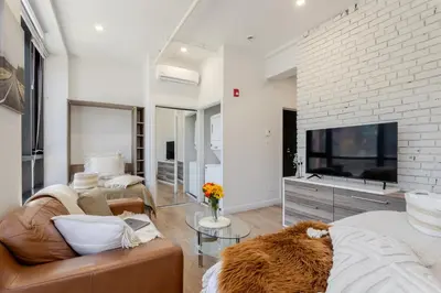 a living room with a couch and a tv at Apartment MTL Dtown Spotlight MTL in Montréal