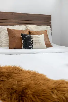 a bed with a pile of pillows on it at Premium Location Stylish 3BR downtown Montreal in Montréal