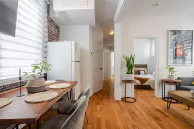 a dining room with a wooden table and chairs at Premium Location Stylish 3BR downtown Montreal in Montréal