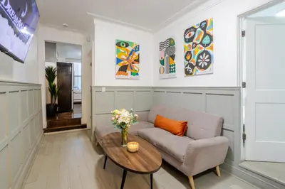 a living room with a couch and a table at Artful 3BR in Montreal Village in Montréal
