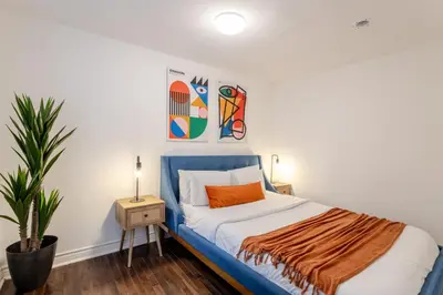a bedroom with a blue and white bed and a plant at Artful 3BR in Montreal Village in Montréal
