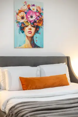 a painting of a woman with flowers on her head at Artful 3BR in Montreal Village in Montréal