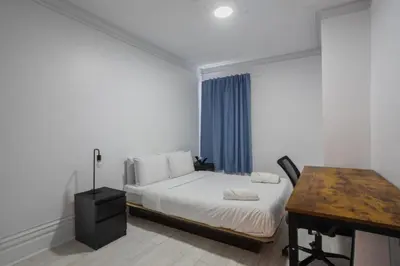 a bedroom with a bed with a desk and a desk at Grand Urban 4BR Luxe Loft in Griffintown in Montréal