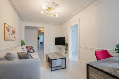 a living room with a couch and a table at Grand Urban 4BR Luxe Loft in Griffintown in Montréal