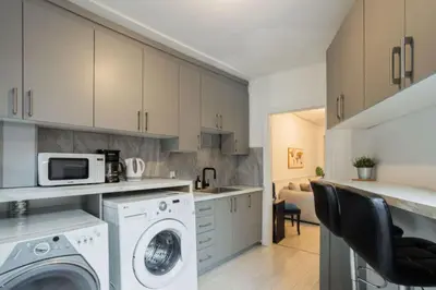 a kitchen with a washing machine and a microwave at Grand Urban 4BR Luxe Loft in Griffintown in Montréal