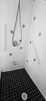 a bathroom with a shower with a tiled floor at The Home Sweet Home 20 Mnt away From Airport in Vaudreuil-Dorion