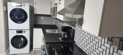 a kitchen with a washer and dryer in a kitchen at The Home Sweet Home 20 Mnt away From Airport in Vaudreuil-Dorion