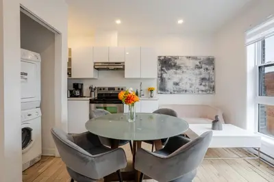 a dining room with a table and chairs and a kitchen at Outstanding 1BR village downtown MTL in Montréal