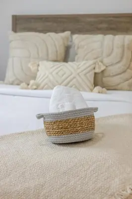 a basket of towels sitting on a bed at Outstanding 1BR village downtown MTL in Montréal