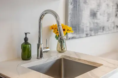 a kitchen sink with yellow flowers next to a faucet at Outstanding 1BR village downtown MTL in Montréal