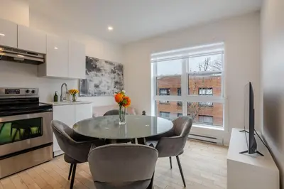 a kitchen with a table and chairs and a television at Outstanding 1BR village downtown MTL in Montréal