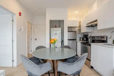 a kitchen with a glass table and chairs at Outstanding 1BR village downtown MTL in Montréal