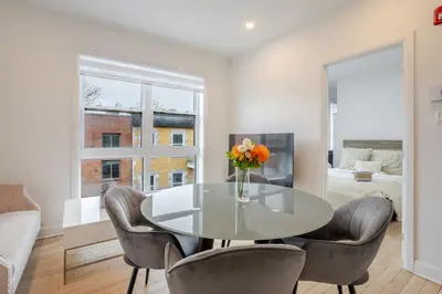 a dining room with a glass table and chairs at Outstanding 1BR village downtown MTL in Montréal