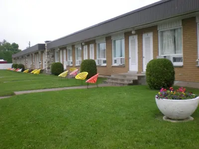 a row of colorful umbrellas in front of a building at Motel Vaudreuil in Vaudreuil-Dorion