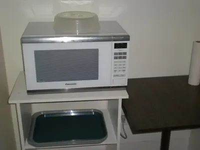 a microwave sitting on top of a table at Motel Vaudreuil in Vaudreuil-Dorion
