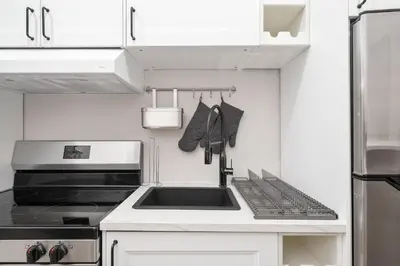 a kitchen with a sink and a stove at Stylish loft in heart of Plateau in Montréal