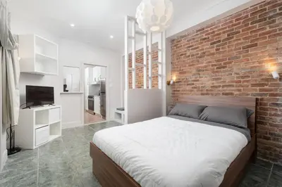 a bedroom with a brick wall and a bed at Stylish loft in heart of Plateau in Montréal