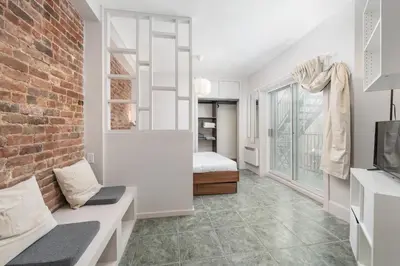 a living room with a couch and a brick wall at Stylish loft in heart of Plateau in Montréal