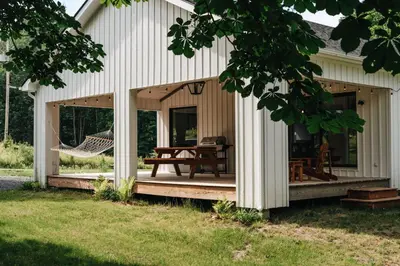 a screened in porch of a house with a hammock at Le Fitzsimmons in Mansonville