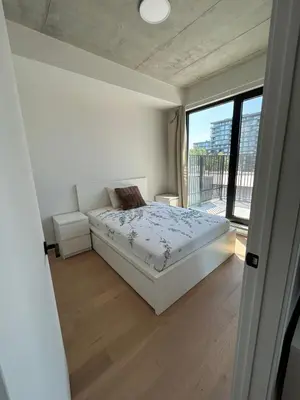 a bedroom with a bed and a large window at Relaxing 2 bedrooms Spa in Montréal