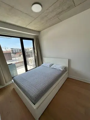 a bedroom with a bed and a large window at Relaxing 2 bedrooms Spa in Montréal
