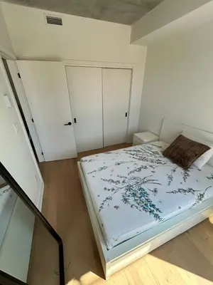 a bedroom with a bed with blue flowers on it at Relaxing 2 bedrooms Spa in Montréal