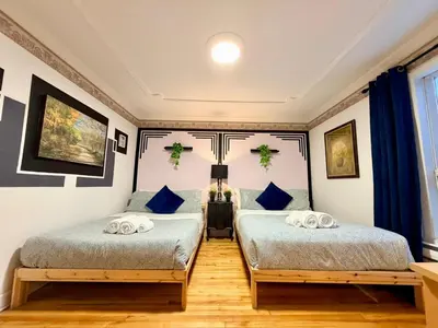 two beds in a room with blue and white walls at City Lights Loft-Free Parking-Sleep 18 in Montréal