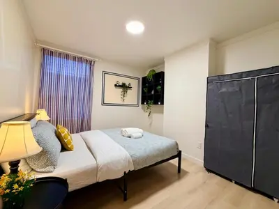 a small bedroom with a bed and a window at City Lights Loft-Free Parking-Sleep 18 in Montréal