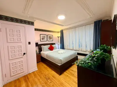 a bedroom with a bed and a window and a door at City Lights Loft-Free Parking-Sleep 18 in Montréal