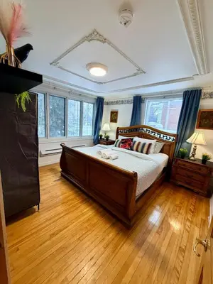 a bedroom with a large bed and wooden floors at City Lights Loft-Free Parking-Sleep 18 in Montréal