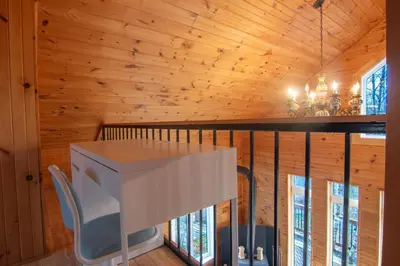 a desk in a room with wooden walls at Vacances Magiques Chalet Skadi Paix Nature in Saint-Justin