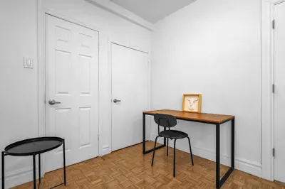 a room with a table and two chairs and a door at Sophisticated Two Bedroom Hideaway in Westmount in Montréal