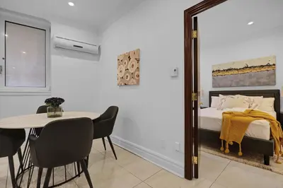 a bedroom with a bed and a table and a mirror at Sophisticated Two Bedroom Hideaway in Westmount in Montréal