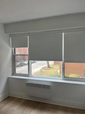 a window with a white blind in a room at Sophisticated Two Bedroom Hideaway in Westmount in Montréal