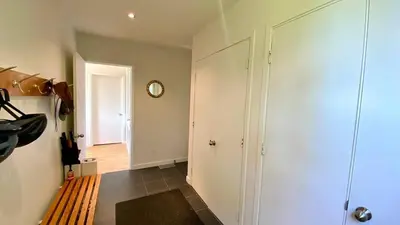 a room with a hallway with a bench and a clock at Le domaine Primavesi in West Brome