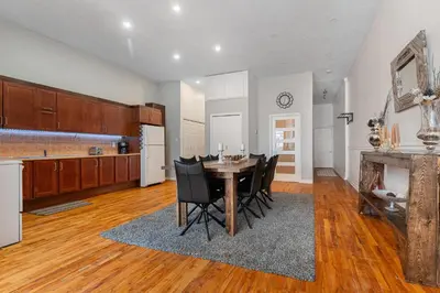 a kitchen and dining room with a table and chairs at Trendy 2BR Getaway in Montreal in Montréal