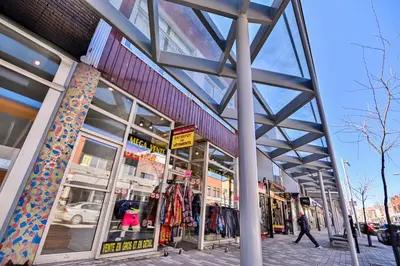 a store front of a building with people walking past it at Trendy 2BR Getaway in Montreal in Montréal