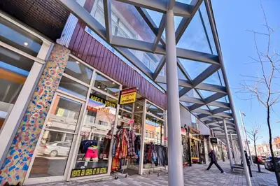 a store front of a building with people walking past it at Trendy 2BR Getaway in Montreal in Montréal