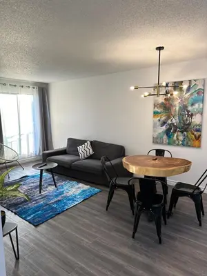 a living room with a couch and a table at The FIVE in Montréal