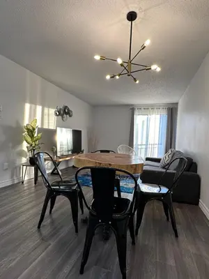a living room with a table and chairs and a couch at The FIVE in Montréal