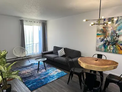 a living room with a couch and a table at The FIVE in Montréal