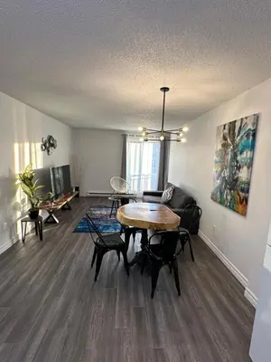 a living room with a table and chairs at The FIVE in Montréal