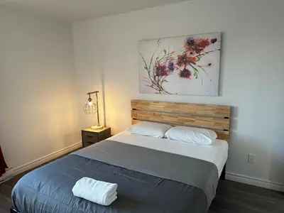 a bedroom with a bed and a painting on the wall at The FIVE in Montréal