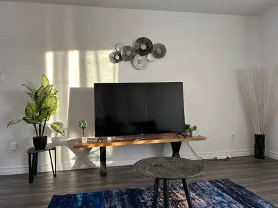 a living room with a flat screen tv on a table at The FIVE in Montréal