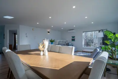 a dining room with a wooden table and chairs at Chalet des Oiseaux Bleus, Spa, Lac in Saint-Gérard