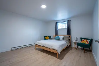 a blue bedroom with a bed and a chair at Chalet des Oiseaux Bleus, Spa, Lac in Saint-Gérard