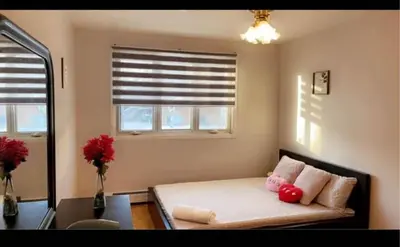 a bedroom with a bed with a red stuffed animal on it at Private bedroom in Montréal