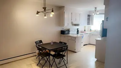 a small kitchen with a table and chairs in it at Private bedroom in Montréal